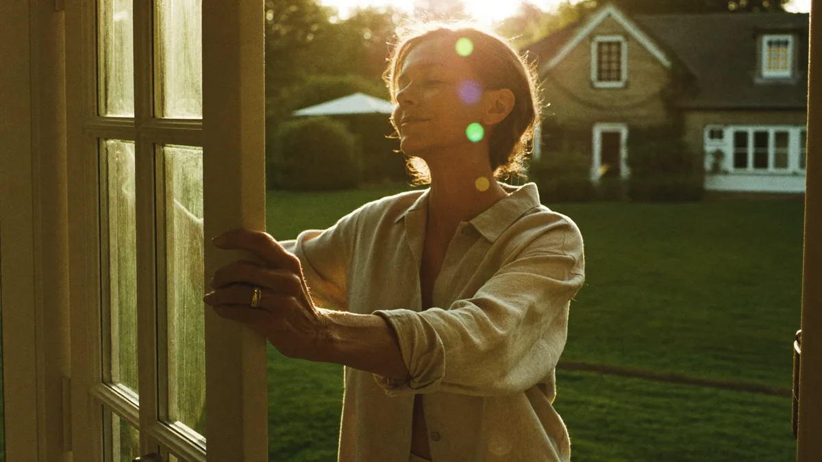 A woman in a sunlit garden